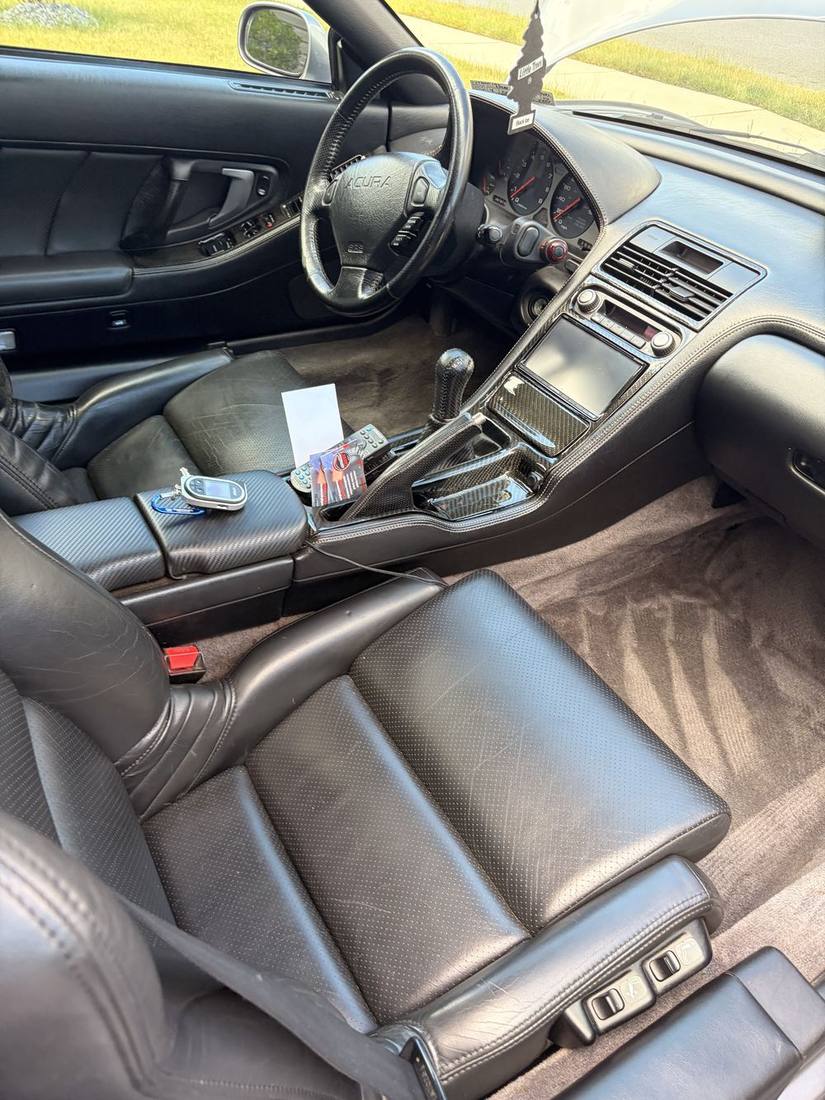 Clean vehicle carpet with fresh vacuum lines and detailed leather seat