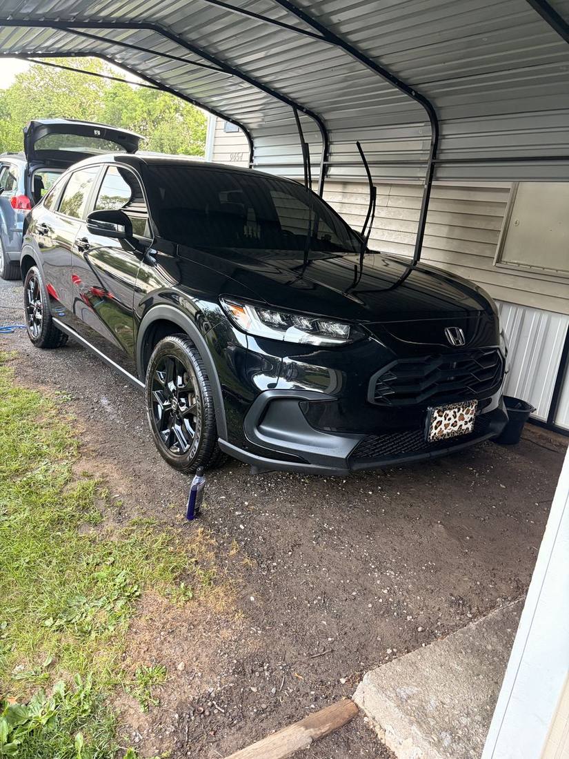 Black Honda SUV with glossy freshly washed paint