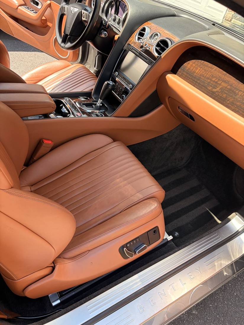 Detailed tan leather interior with clean seats, console and floor mats